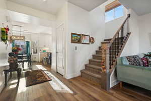 Stairway featuring hardwood / wood-style flooring