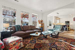 Living room with a notable chandelier and hardwood / wood-style flooring