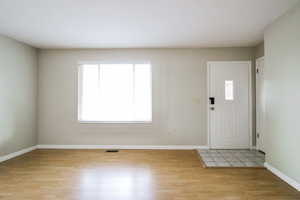 Entrance foyer featuring plenty of natural light and light hardwood / wood-style flooring