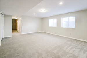 Empty room featuring light colored carpet