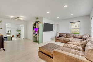 Living room with light hardwood / wood-style floors and a textured ceiling