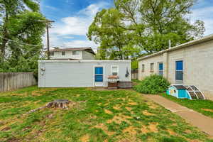 Rear view of property with a lawn