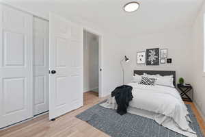 Bedroom with a closet and light hardwood / wood-style flooring