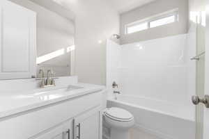 Full bathroom with vanity, shower / tub combination, and toilet