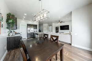 Dining room featuring baseboards, a ceiling fan, wood finished floors, and visible vents