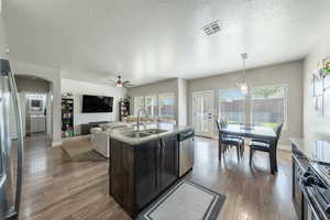 Kitchen featuring stainless steel dishwasher, a sink, visible vents, a ceiling fan, and gas stove