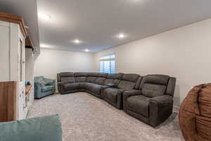 Carpeted living room with a textured ceiling