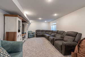 Living room featuring a textured ceiling and light colored carpet