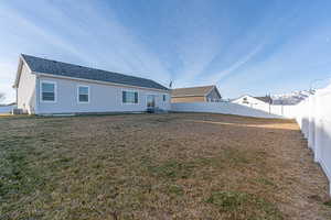 Rear view of house featuring a lawn