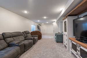 Carpeted living room featuring a textured ceiling