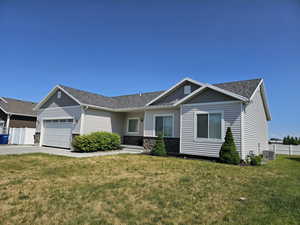 View of front facade featuring roof with shingles, a garage, board and batten siding, concrete driveway, and central AC unit