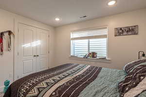 Bedroom featuring a textured ceiling and a closet