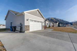 View of home's exterior with a mountain view and a garage