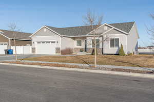 Ranch-style house with cooling unit and a garage