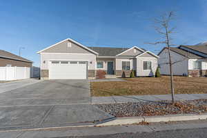 View of front of house featuring a front lawn and a garage