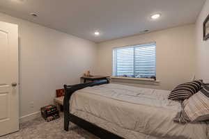 Bedroom featuring carpet floors and a textured ceiling