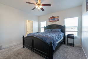 Bedroom featuring dark carpet and ceiling fan