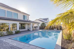 View of pool featuring pool water feature and a patio area