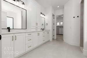 Bathroom featuring tile patterned flooring and vanity