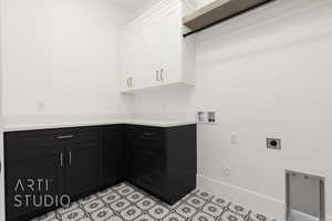 Clothes washing area featuring washer hookup, electric dryer hookup, cabinets, and hookup for a gas dryer