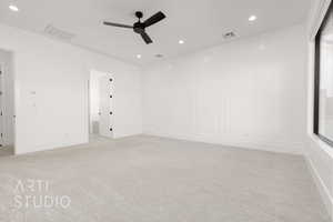 Carpeted spare room featuring ceiling fan