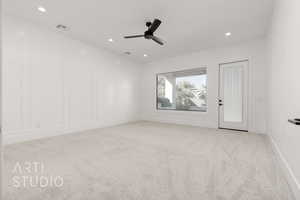 Empty room featuring light carpet and ceiling fan