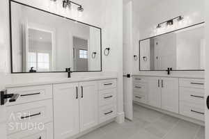 Bathroom featuring tile patterned flooring and vanity