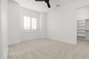 Spare room featuring light colored carpet and ceiling fan