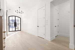 Interior space featuring an inviting chandelier and light hardwood / wood-style flooring