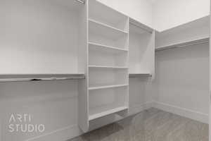 Spacious closet featuring carpet flooring