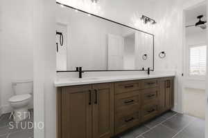 Bathroom with tile patterned flooring, vanity, and toilet