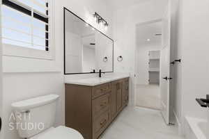 Bathroom with vanity, toilet, and a bath