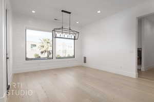 Unfurnished dining area featuring light hardwood / wood-style flooring