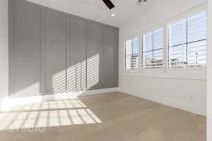 Empty room with light hardwood / wood-style flooring and ceiling fan