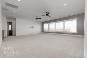 Carpeted spare room with ceiling fan