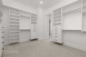 Walk in closet featuring light carpet