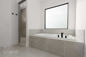 Bathroom featuring tile patterned floors and independent shower and bath