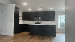 Kitchen with wood-type flooring and stainless steel appliances