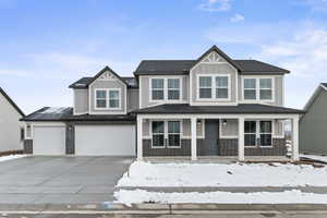 View of front of house featuring a garage and a porch