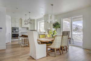 Dining space featuring a mountain view, sink, and light hardwood / wood-style flooring