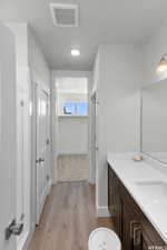 Bathroom featuring vanity and wood-type flooring