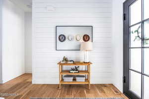 Room details featuring hardwood / wood-style floors and wood walls