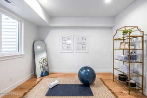 Workout room with hardwood / wood-style flooring