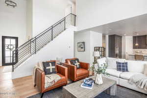 Living room featuring a high ceiling and light wood-type flooring