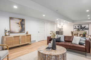 Living room with wood-type flooring and sink