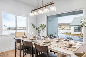 Dining space featuring a water view and light hardwood / wood-style floors