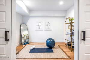 Workout area featuring wood-type flooring