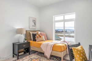 Bedroom with carpet floors and multiple windows