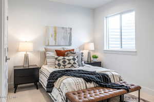 Bedroom featuring multiple windows and carpet floors