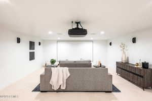 Home theater room with light carpet